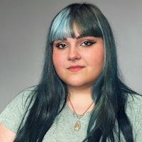 a woman with blue hair posing for a photo